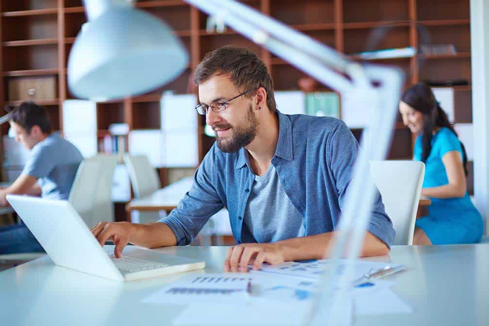 Man at computer in open plan office