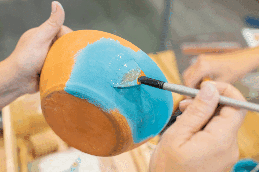 Hand painting a pot