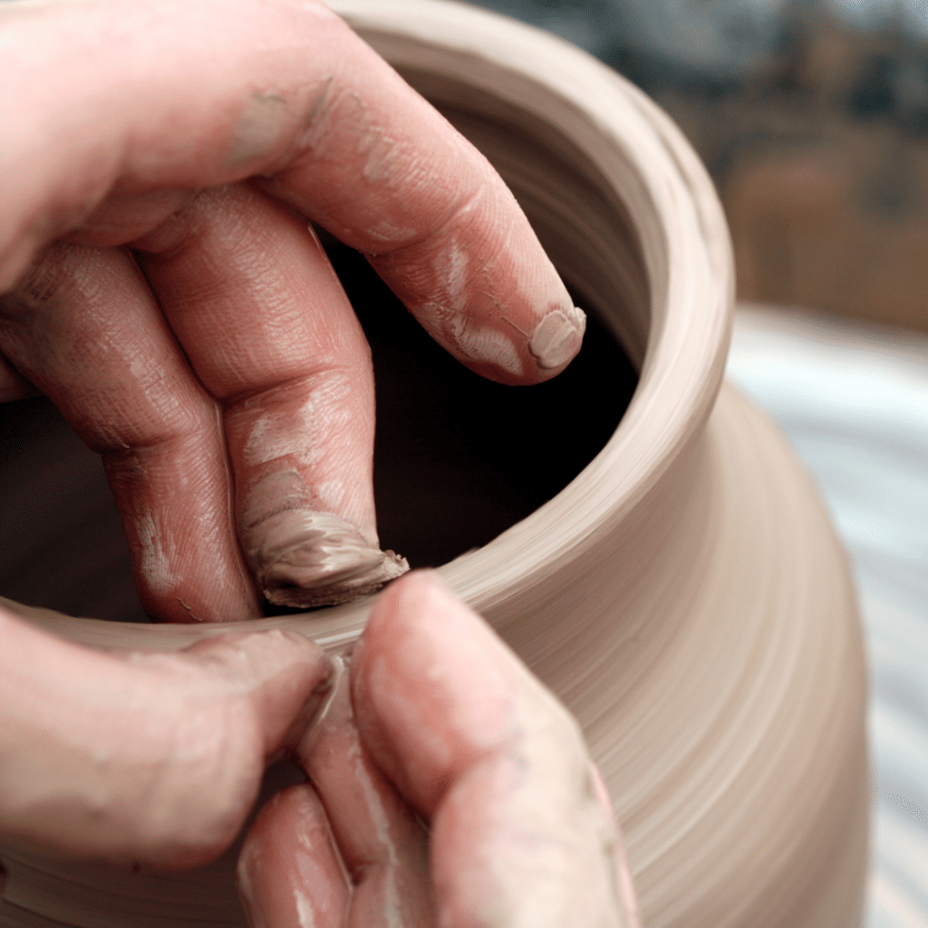 Hands throwing a pot